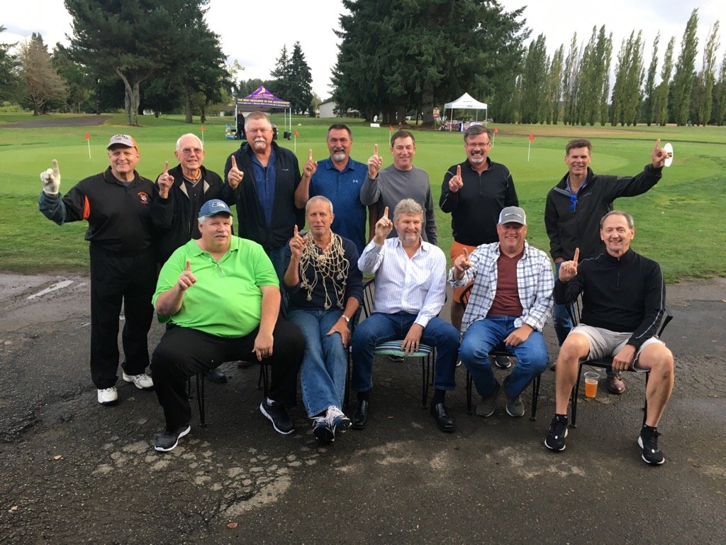 Former Centralia High School boys basketball coach Ron Brown (center) poses with members of the 1979 state champion Tiger basketball team at Newaukum Valley Golf Course during a fund-raiser golf tournament.